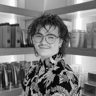 Portrait of Ezra, a professional stylist at PR At Partners, showcasing their expertise and style.